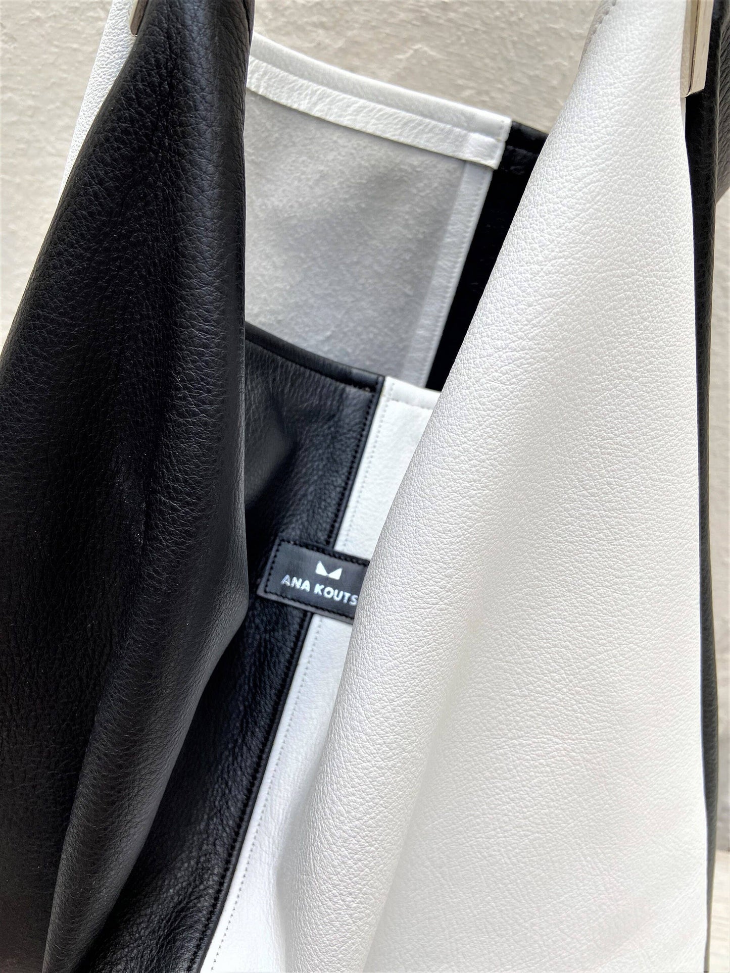 ANA KOUTSI - Akathi double leather bag in black & white